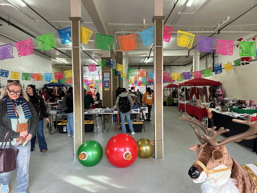 A woman standing next to a reindeer.