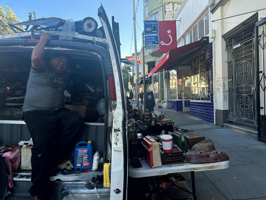 Justo Garcia, one of Mission Street's vendors, standing in front of a van.