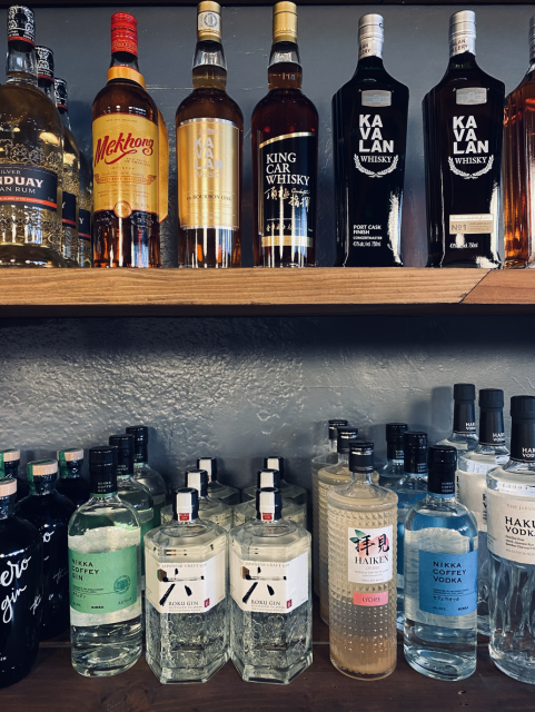 Th Rabbut Hole's shelf filled with alcohol bottles. 