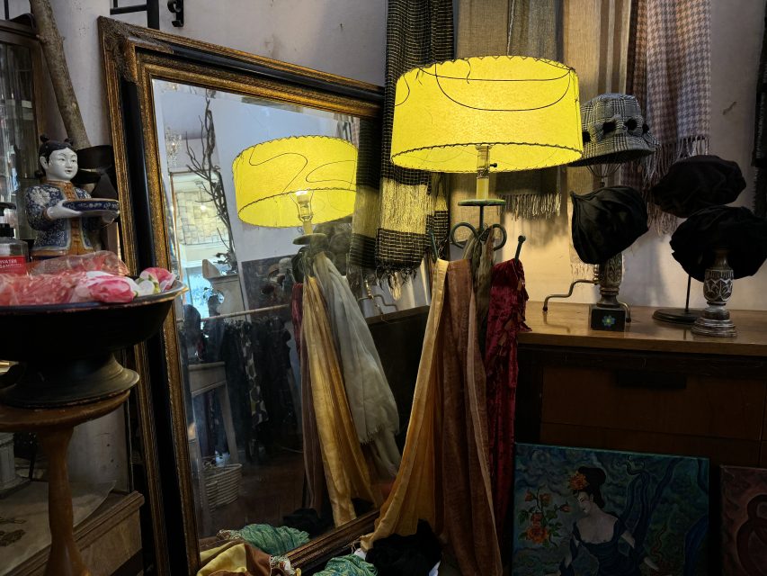 A yellow lamp next to a mirror.