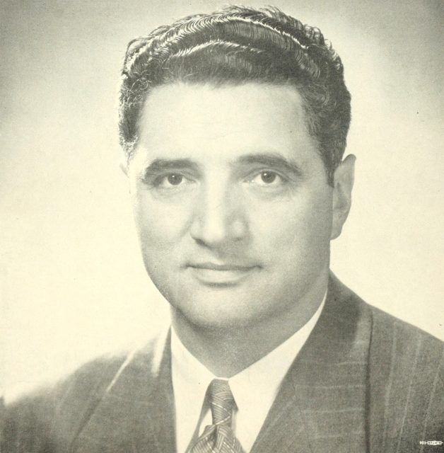 The mayor in a suit and tie.