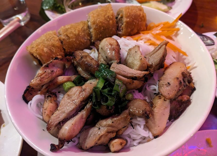 Vietnamese noodle bowl with meat and vegetables.
