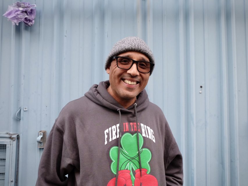 A man wearing glasses and a hoodie.