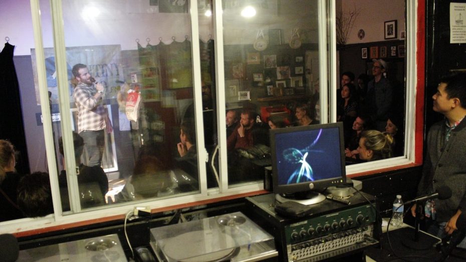 A group of people standing in front of a window.