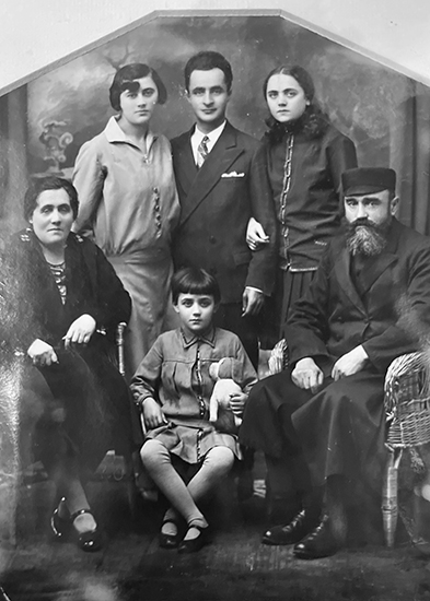 An old photo of a family posing for a picture.