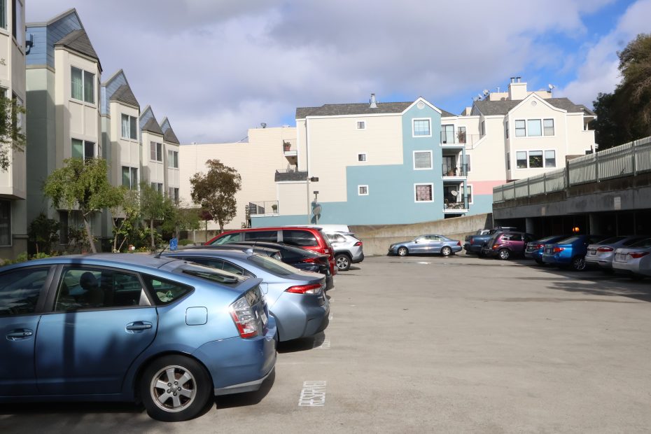 A blue car parked in a parking lot.