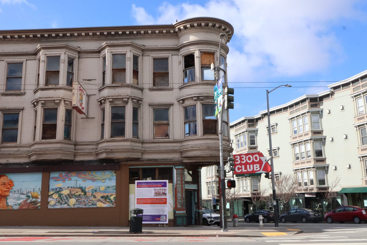 A building with a corner and a sign on the corner.