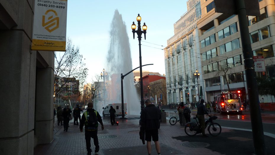 A fire hydrant in the middle of a city street.