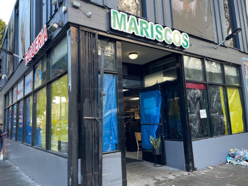 The front of a store with a sign on it.