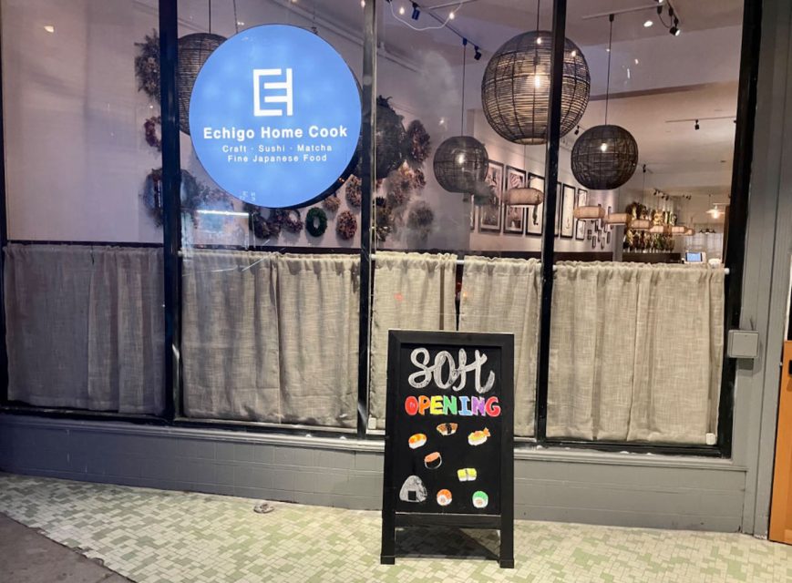 A store displaying a chalkboard sign for Echigo Home Cook.