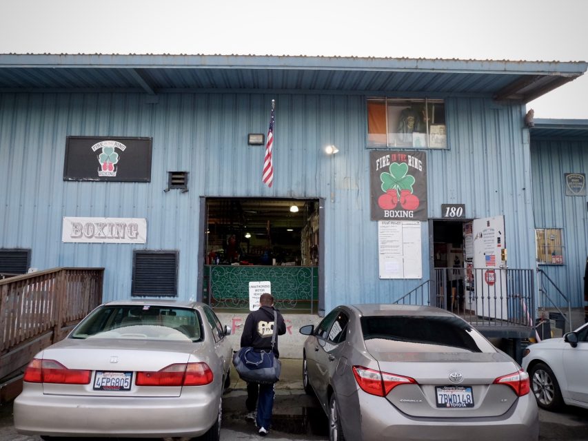A man walks in a blue warehouse building