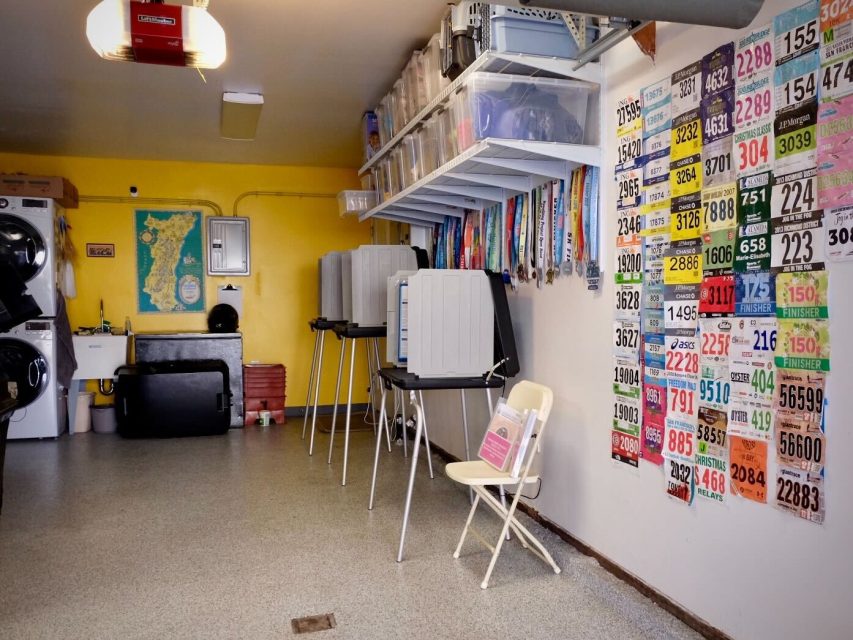 A garage turned polling center, with race bibs on the right side wall