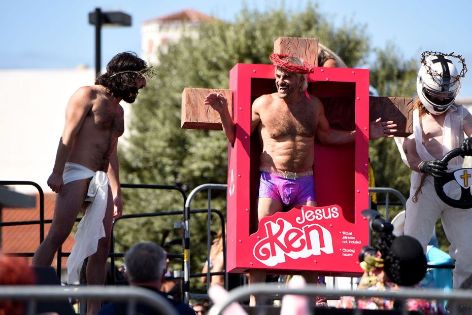 A person dressed as a parody version of "jesus ken" in a mock toy box during Hunky Jesus.
