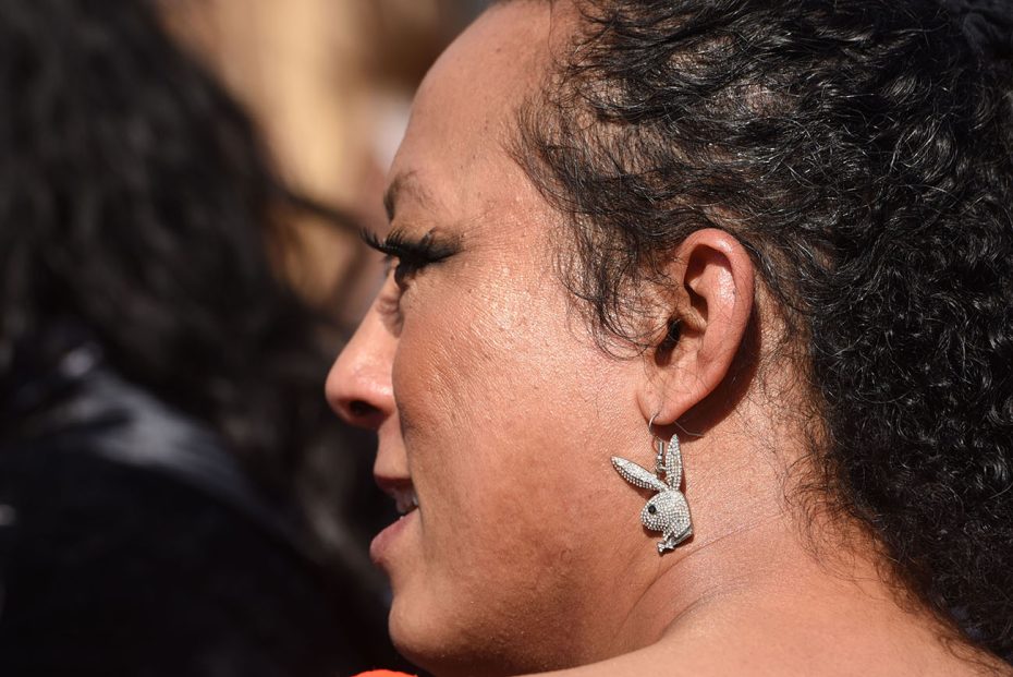 Side profile of a person with a distinctive bunny-shaped earring.