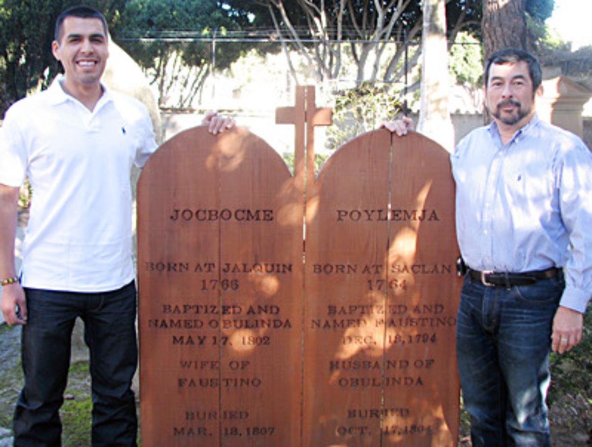 Vincent Medina (left) and Andrew Galvan stand next to a memorial for their ancestors, Jobocme and Poylemja, in the Mission Dolores cemetery. Photo courtesy Andrew Galvan.