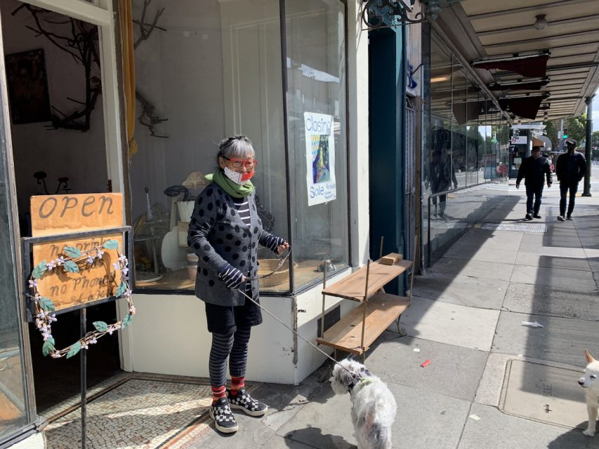 Yaeko Yamashita stands with her dog outside her shop, Laku, on March 30, 2024.
