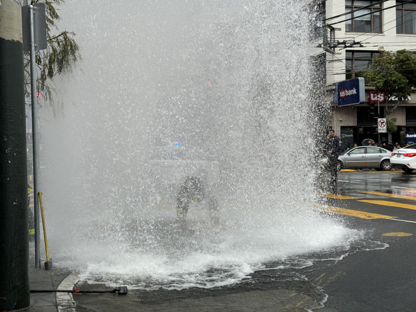 A fire hydrant gushing water into the air at 16th and Mission streets