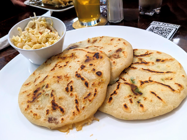 A plate of pupusas served with a side of curtido at Sarita's Grill and Beer