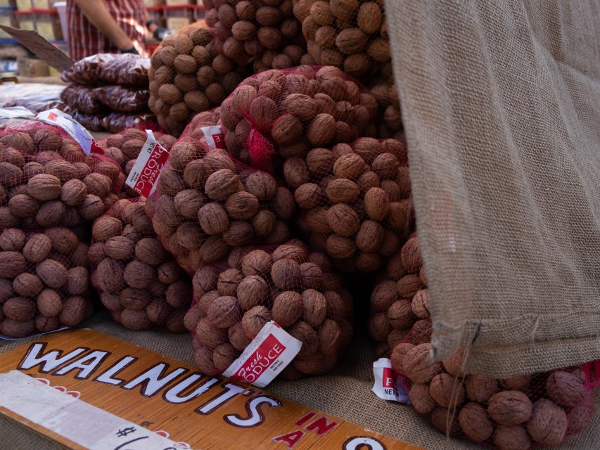 Bags of walnuts for sale at a market stall.