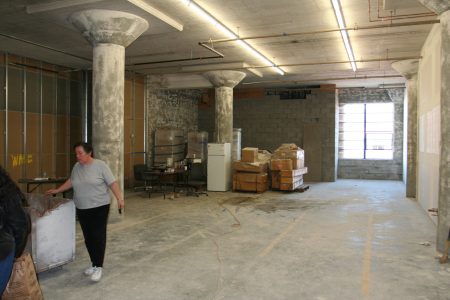 Landlord Vera Cort walks by the 1890 Bryan during construction