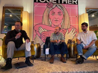 Three individuals sitting on stage during a panel discussion on political donors with a backdrop that reads "together at BigMoneySF.