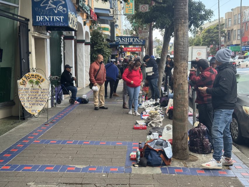 People engaging in street vending on Mission Street.